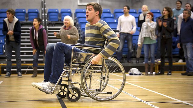A screencap from Siblings episode 'Wheelchair Conference', with ble-bodied Tom Stourton playing able-bodied Dan who is pretending to be disabled.